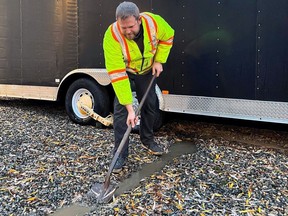 Chilliwack resident Kris Armstrong, 37, digging a moat around his property, which was previously flooded during a mid-November storm, in preparation of rain storms expected this weekend.