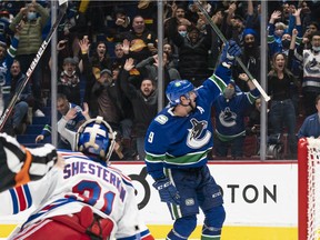 J.T. Miller of the Vancouver Canucks celebrates after scoring the game winning goal against goalie Igor Shesterkin of the New York Rangers during the overtime period on November 2, 2021 at Rogers Arena in Vancouver, British Columbia, Canada.