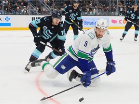 Vancouver Canucks defenceman Tucker Poolman, seen here on Oct. 23 against the Seattle Kraken, is facing a suspension for hitting Colorado's Kiefer Sherwood in the head with his stick on Thursday night.