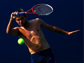 Daniel Evans of Great Britain plays a forehand during a practice session on Day Two of the 2013 US Open.