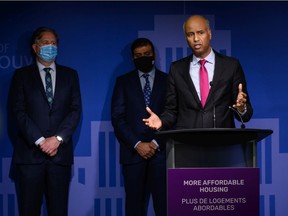 Federal housing minister Ahmed Hussen (right) speaks at a press conference on housing at Vancouver city hall, while Vancouver Mayor Kennedy Stewart (left) watches, on Nov. 15, 2021. Credit: Milos Tosic - CNW