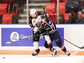 It's a battle of No. 27s as Vancouver Giants defenceman Alex Cotton tries to hold Tai-City Americans winger Rhett Melnyk in a battle for the puck Friday in Kennewick, Wash.