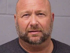 In this handout photo provided by the Travis County Sheriffs Office, InfoWars founder Alex Jones is seen in a police booking photo in Austin after his arrest on charges of driving while intoxicated after a traffic stop in Travis County, Texas, March 10, 2020.
