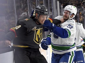 Golden Knights defenceman Brayden McNabb and Vancouver Canucks defenceman Oliver Ekman-Larsson get into a scuffle in the first period at T-Mobile Arena in Las Vegas.