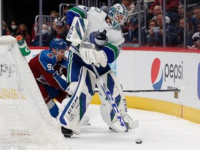 Canucks goalie Thatcher Demko controls the puck under pressure from Colorado Avalanche left-winger Gabriel Landeskog at Ball Arena. He was hung out to dry by his teammates in a sobering loss in Denver.
