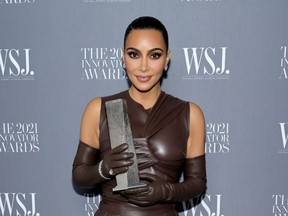 Kim Kardashian West poses with an award during the WSJ. Magazine 2021 Innovator Awards sponsored by Samsung, Harry Winston, and Remy Martin at MOMA in New York City, Monday, on Nov. 1, 2021.