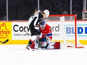 Vancouver Giants forward Ty Thorpe tries to get one by Spokane Chiefs netminder Manny Panghli on Saturday in Spokane.