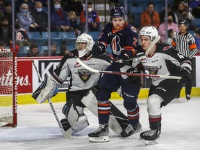 Mazden Leslie (right) of the Giants and Logan Bairos of the Kamloops Blazers jockey for position in front of Vancouver netinder WIll Gurski last month.