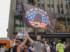 In this file photo, conspiracy theorist QAnon demonstrators protest child trafficking on Hollywood Boulevard in Los Angeles August 22, 2020.