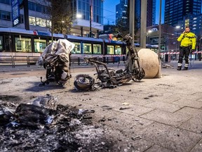 This photograph taken on November 20, 2021 shows a burned electric scooter after a protest against the partial lockdown and against the 2G government policy in Rotterdam.