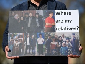 In this file photo a member of the Uyghur community holds a placard as he joins a demonstration to call on the British parliament to vote to recognise alleged persecution of China's Muslim minority Uyghur people as genocide and crimes against humanity in London on April 22, 2021.