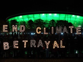Youth activists hold up letters in Glasgow during the COP26 Climate Change Conference this week.
