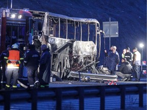 Officials work at the site of a bus accident, in which at least 45 people were killed, on a highway near the village of Bosnek, south of Sofia, on November 23, 2021.