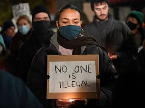 Protestors hold placards as they demonstrate against the British Government's policy on immigration and border controls, outside of the Home Office in central London on November 25, 2021, following the death of 27 migrants crossing the English channel - Britain on Thursday demanded a "coordinated international effort" across Europe to deter people-smuggling after at least 27 migrants drowned as they tried to reach England on Wednesday.