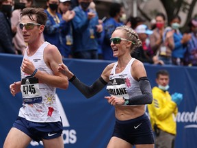 Shalane Flanagan crosses the finish line during the 2021 Boston Marathon.