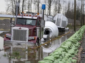 A truck gets swallowed up by rising flood waters from the United States as waters cross the border into Abbotsford, B.C.,