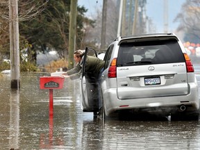 Renee Reeves delivers an apple crisp to a home in the evacuation zone after rainstorms lashed the western Canadian province of British Columbia.