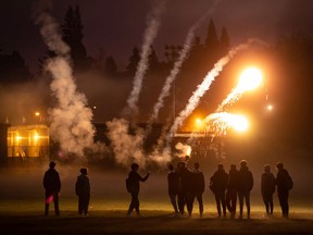 A group of young men shoot off fireworks on Halloween in Vancouver, on Saturday, October 31, 2020.