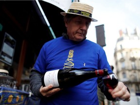 Alain Fontaine, owner of the Le Mesturet restaurant, pours a glass of Beaujolais Nouveau wine on the terrace of his bistrot in Paris, France, November 18, 2021.
