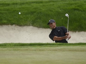 Tiger Woods hits out of the bunker on the second hole during the first round of the Zozo Championship golf tournament at Sherwood Country Club.