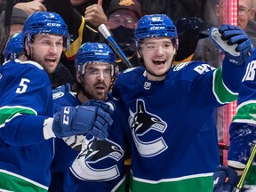 Canucks winger Vasily Podkolzin (right) has had a lot to smile about during his rookie NHL season.