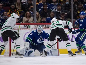 Canucks goalie Thatcher Demko thwarts Dallas Stars winger Jason Robertson, who is parked on his doorstep but can't get the puck past him during their Sunday game at Rogers Arena. Demko has faced the second most shots of any NHL goaltender so far this season.