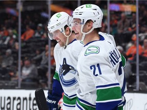 Canucks winger Nils Hoglander celebrates his goal against the Ducks with linemate Tanner Pearson on Nov. 14, 2021 in Anaheim.
