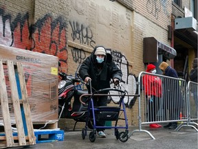 People stand outside of a supervised injection site in the Washington Heights section of New York City, U.S., November 30, 2021.