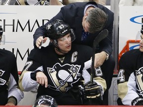 Pittsburgh Penguins' Sidney Crosby (87) talks with head coach Mike Sullivan during an NHL hockey game against the Ottawa Senators in Pittsburgh in 2016.