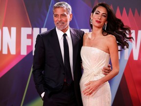 Director George Clooney and his wife lawyer Amal Clooney arrive for a screening of the film "The Tender Bar" as part of the BFI London Film Festival, in London, Britain, October 10, 2021.
