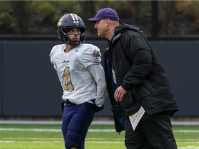 Vancouver College Fighting Irish quarterback Alex Zychlinski and head coach Todd Bernett talk during a break in the action against the Notre Dame Jugglers on Nov. 6 The high school playoffs changed up on Wednesday due to travel limitations in the province.