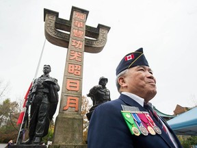 Kelly Kwong at the Remembrance Day ceremony at the Chinatown Memorial Plaza in Vancouver on Nov. 11, 2021. The Chinatown Memorial Monument is by sculptor Arthur Shu-ren Cheng, unveiled in 2003. Bronze statues of a railway worker and WWII vet represent their sacrifices. The main column is a stylized form of the Chinese character “centre” which symbolizes Chinese culture.