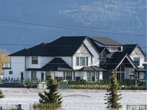 A home is surrounded by flood waters in Abbotsford, BC, November, 17, 2021.