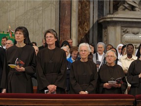 Sister Raffaella Petrini (L) looks on during a mass in Saint Peter's Basilica at the Vatican, in this undated handout photo obtained by Reuters on November 4, 2021.