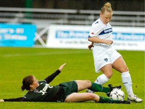 Carey Gustafson (right) battles for the ball against the Seattle Sounders during a 2007 W-League match at Swangard Stadium.