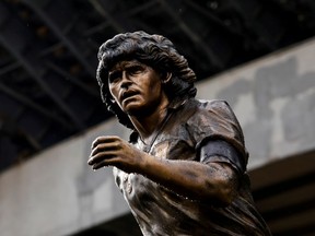 A statue of Argentinean soccer legend, Diego Armando Maradona, made by Italian sculptor Domenico Sepe, is unveiled in front of the stadium on the first anniversary of his death in Naples, Italy, November 25, 2021.