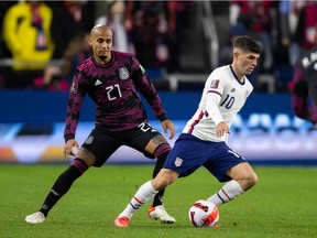 Nov 12, 2021; Cincinnati, Ohio, USA; United States forward Christian Pulisic (10) dribbles the ball while Mexico defender Luis Rodriguez (21) defends during a FIFA World Cup Qualifier soccer match at TQL Stadium. Mandatory Credit: Trevor Ruszkowski-USA TODAY Sports
