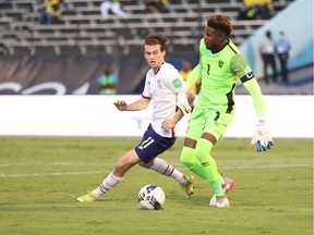 Jamaica's Andre Blake in action with Brenden Aaronson of the U.S.