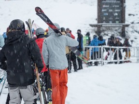 People line up to board a lift on opening day, Thursday, at Whistler Blackcomb.