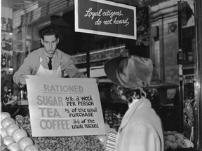 A Canadian shop owner puts up a rationing sign in 1942.