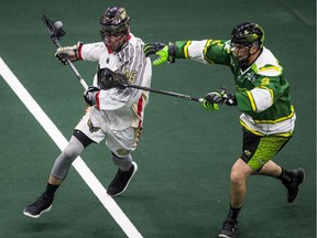 Philadelphia Wings transition/defender Kiel Matisz and Saskatchewan Rush defender Brett Mydske battle for the ball during NLL action in Saskatoon on April 13, 2019.