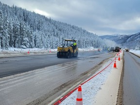 Temporary repairs needed to reopen the Coquihalla Highway are nearing completion. Here the new road surface is paved on Dec. 14 at Murray Flats on Highway 5, where the highway and major culverts were washed away.