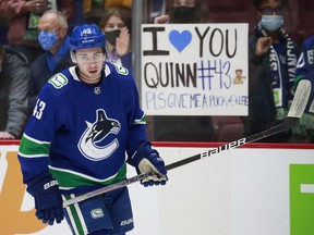 Canucks defenceman Quinn Hughes gets some love from Vancouver hockey fans prior to an October game at Rogers Arena.