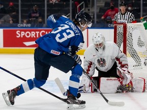 Brad Lambert of Finland skates against goaltender Sebastian Wraneschitz of Austria in the first period during the 2022 IIHF World Junior Championship at Rogers Place on Dec. 27, 2021 in Edmonton. The U.S was forced to forfeit the game against Switzerland on Tuesday due to two positive COVID tests among its players. Canada is scheduled to play Austria on Tuesday night.