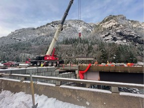 A replacement piece is lowered into place at the damaged Jessica Bridge, southbound side, on the Coquihalla freeway. The bridge was damaged during the atmospheric river rains of Nov., 14-15.