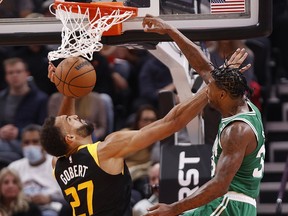 Boston Celtics guard Marcus Smart (36) dunks over Utah Jazz centre Rudy Gobert (27) in the second quarter at Vivint Arena.