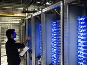 (FILES) This file photo taken on July 21, 2014 shows an employee of Equinix data center checking servers on July 21, 2014 in Pantin, a suburb north of Paris in the Seine-Saint-Denis department.   The world's biggest ransomware attack levelled off in Europe on May 15, 2017 hanks to a pushback by cyber security officials after causing havoc in 150 countries, as Microsoft urged governments to heed the "wake-up call". / AFP PHOTO / MARTIN BUREAUMARTIN BUREAU/AFP/Getty Images ORG XMIT: -