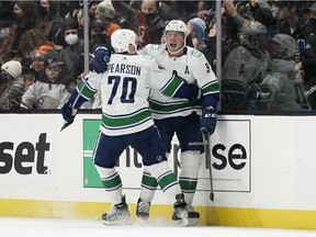 Vancouver Canucks' J.T. Miller, right, and Tanner Pearson celebrate Miller's overtime goal against the Anaheim Ducks in an NHL hockey game Wednesday, Dec. 29, 2021, in Anaheim, Calif. The Canucks won 2-1.