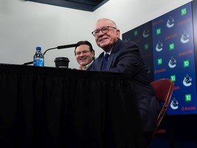 Canucks President and Interim General Manager Jim Rutherford, front, and Canucks owner Francesco Aquilini are all smiles at their first news conference together on Monday.