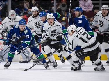 Vancouver Canucks' Tyler Motte (64) vies for the puck against Los Angeles Kings' Rasmus Kupari (89), of Finland, and Trevor Moore (12) during first period NHL hockey action in Vancouver, B.C., Monday, Dec. 6, 2021.